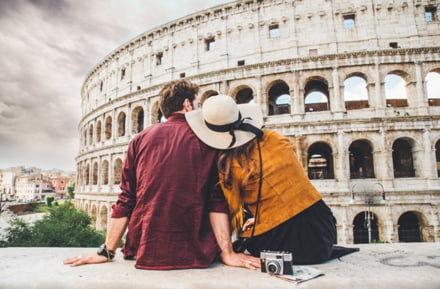 A couple in love in front of the Colosseum