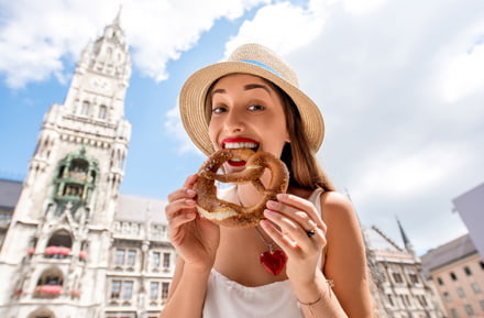 Young female tourist holding traditional bavarian bread